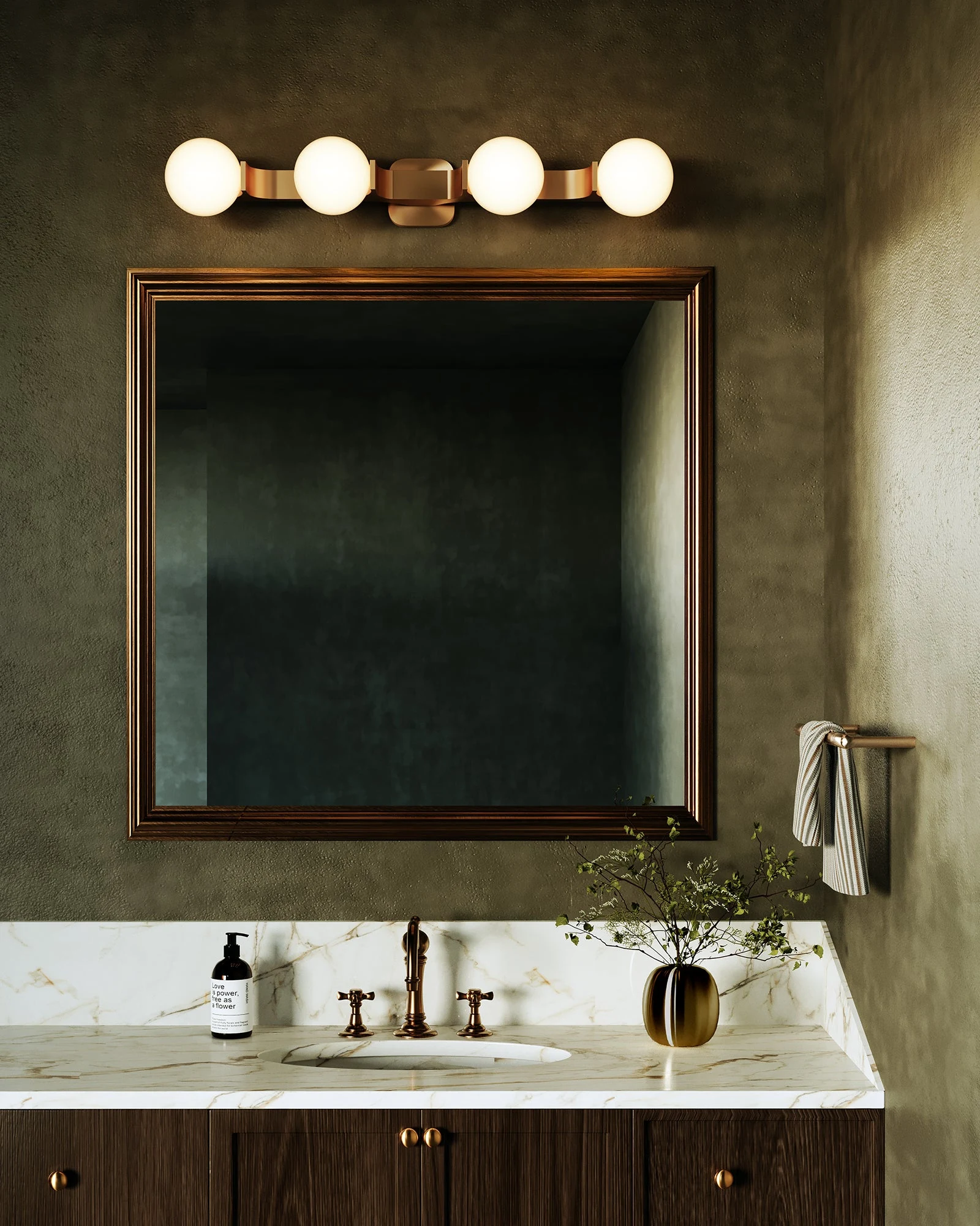 Briar vanity light above a framed mirror in a dark green bathroom
