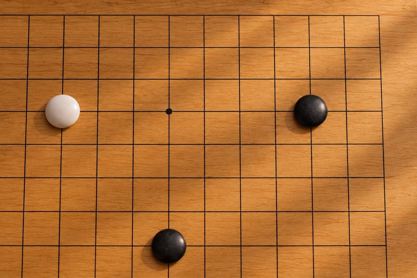 Black and white stones on a wooden Go board