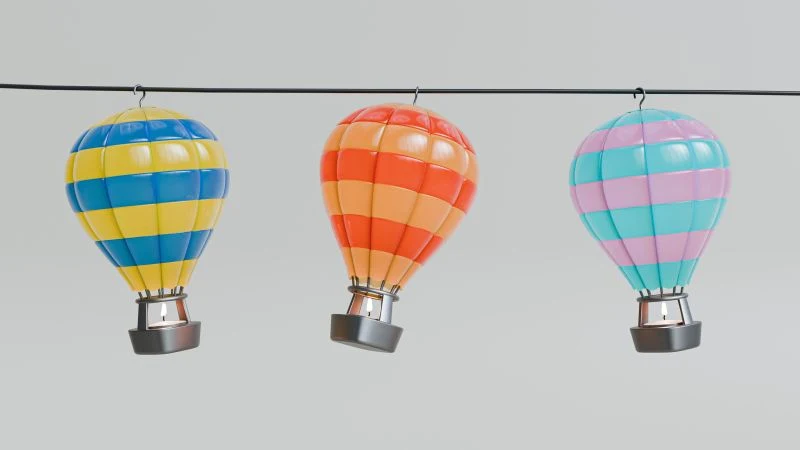 Three coloured balloon-shaped tea candle holder concepts